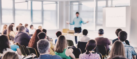 Man speaking to room of people