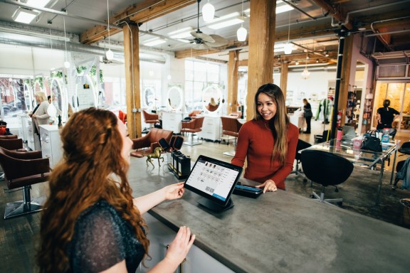 Woman completing transaction in store