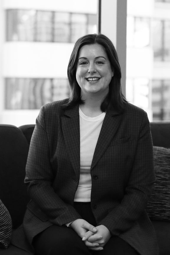 Kristy Martin smiles on a couch in the BC offices
